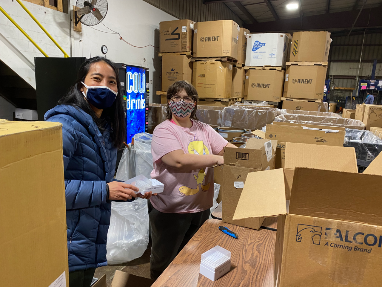 Cynthia Lin, global sustainability manager, Life Sciences, helps sort packaging from Corning’s takeback program with employee Katrina.